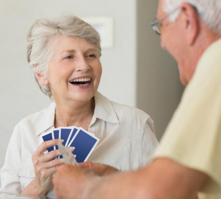 happy-senior-couple-playing-a-card-game